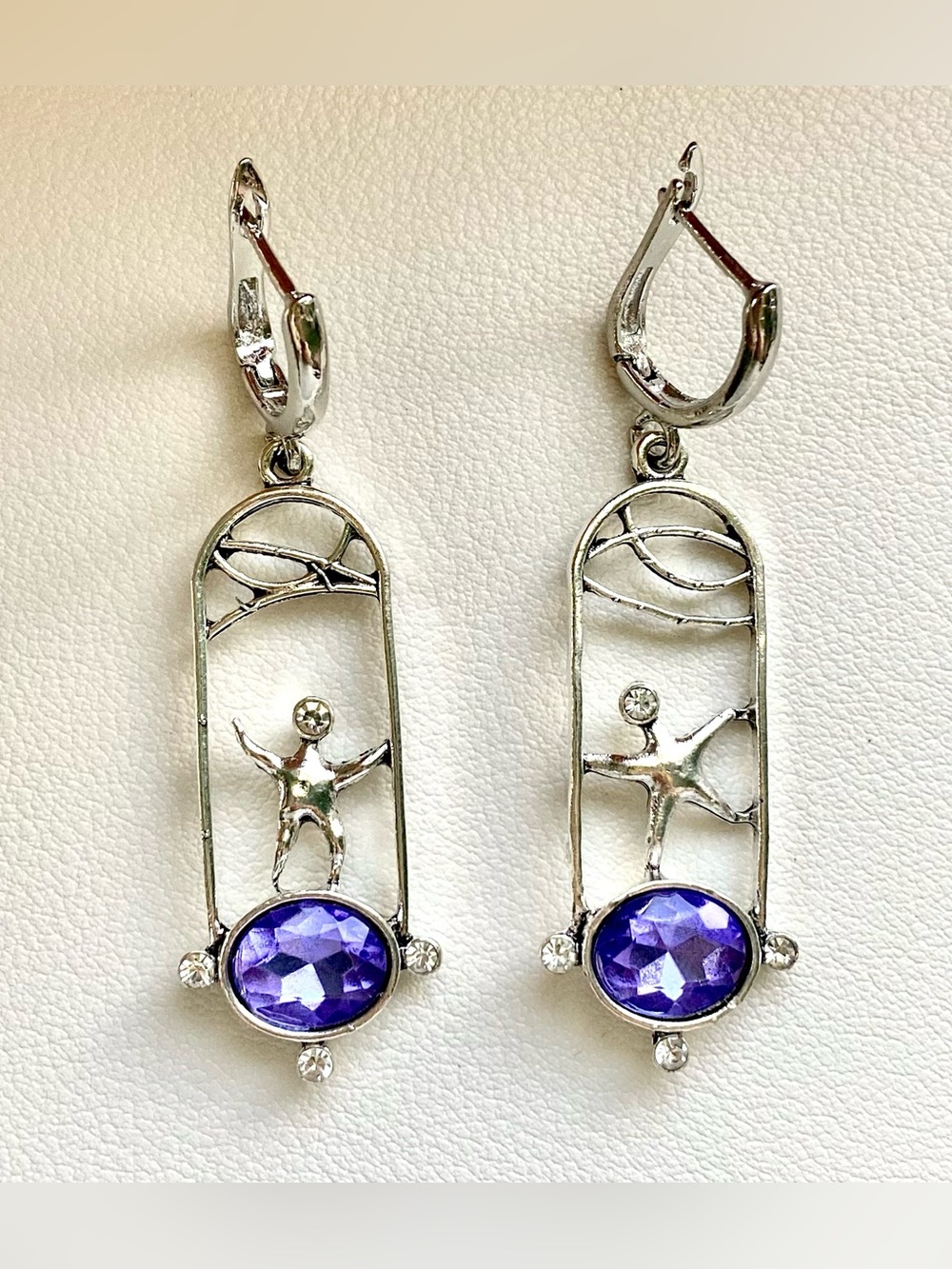 Silver and purple gemstone earrings with a whimsical design
